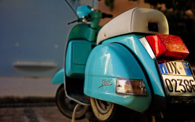A vintage blue scooter shows its rear side with a white seat and license plate, HD Desktop Wallpaper