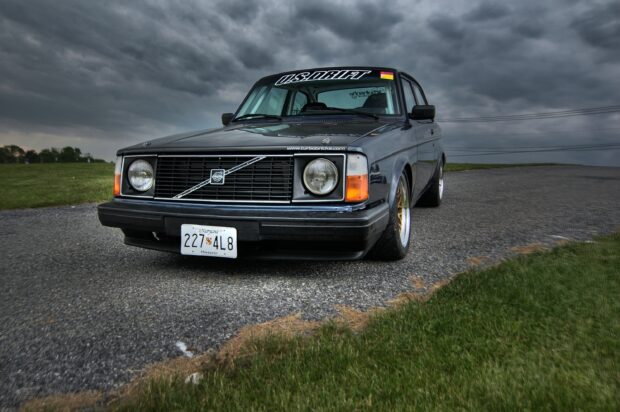 Classic Volvo car parked on a road under a cloudy sky