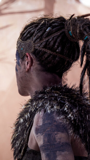 A warrior with tribal tattoos and braided hair looks into the distance, HD Phone Wallpaper