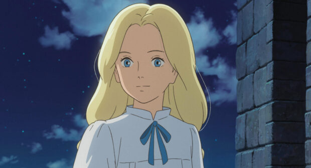 A blonde girl with blue eyes from When Marnie Was There stands near a stone wall at night