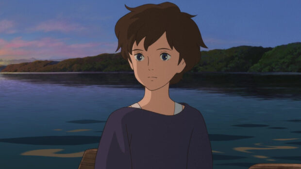 A young girl from When Marnie Was There anime sits quietly on a boat during sunset