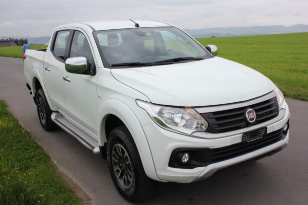 A white Fiat Fullback pickup truck parked on a countryside road with green fields in the background, HD Desktop Wallpaper