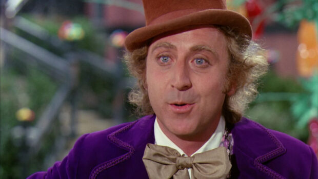 Willy Wonka character wearing a purple coat and brown hat with a bow tie