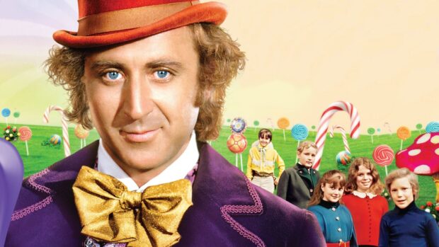 Willy Wonka character wearing a purple coat and golden bow tie standing in a colorful candy field with children in the background