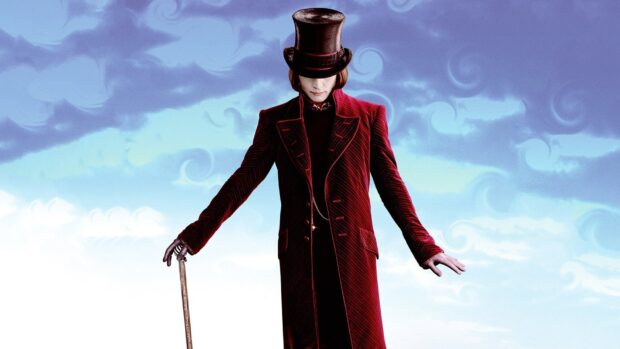 Willy Wonka character wearing a red velvet coat and top hat holding a cane against a cloudy sky background