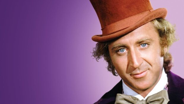 Willy Wonka character in his iconic hat and suit with a purple background