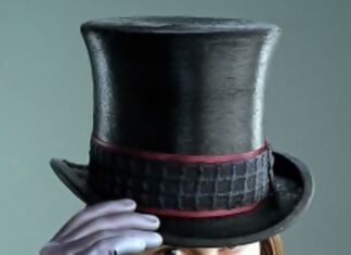A close up of Willy Wonka wearing a top hat and purple glove