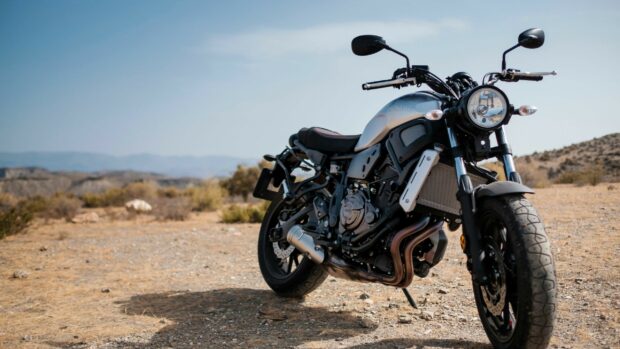 A Yamaha motorcycle parked on a dry landscape under a clear sky
