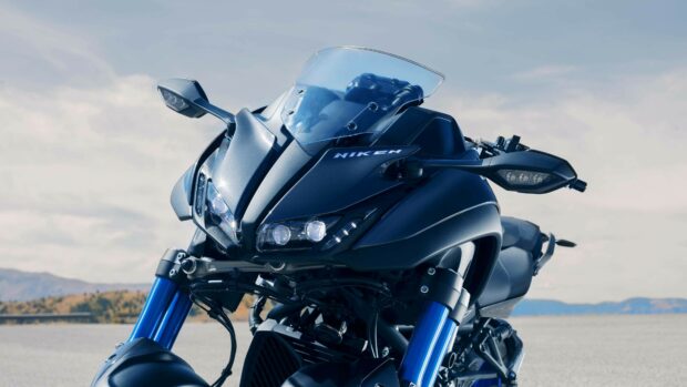 Close up of Yamaha Niken motorcycle front with blue suspension and clear windshield