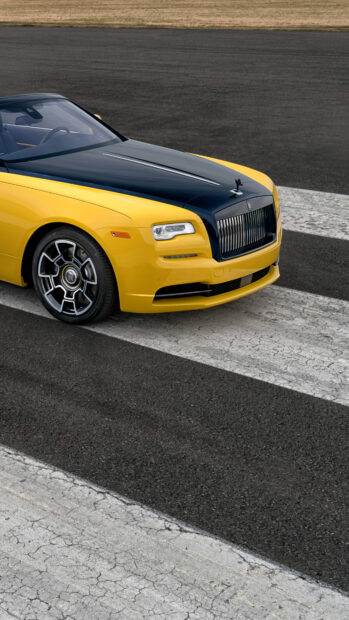 The Rolls Royce Dawn shows its yellow and black exterior in a close up shot on the road, 4K Phone Wallpaper