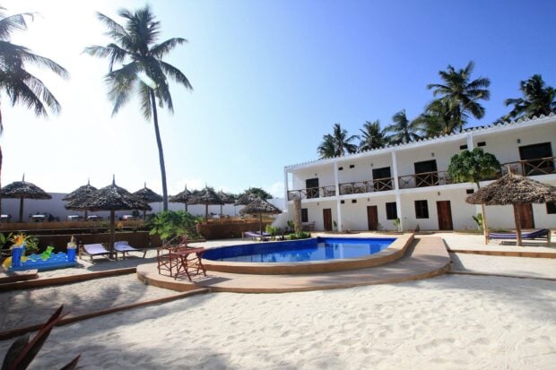 A sunny tropical resort in Zanzibar with palm trees and a pool, 2K Desktop Wallpaper