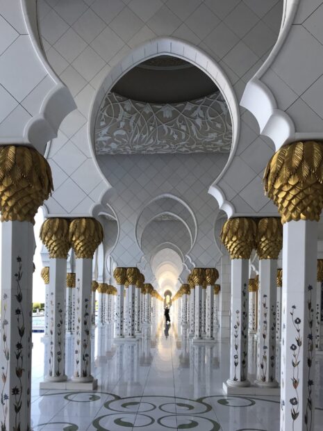 Architectural details of Abu Dhabi mosque columns decorated with gold and floral patterns