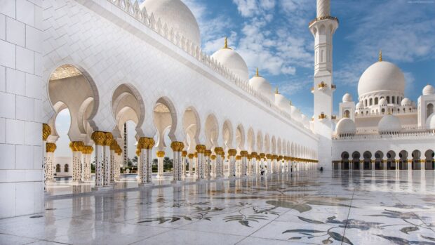 The elegant mosque architecture of Abu Dhabi with white domes and golden decorated columns