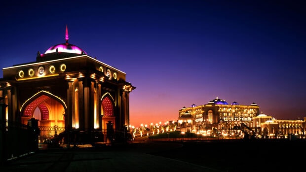 The grand architecture of Abu Dhabi illuminated during twilight showcasing beautiful lights and domes