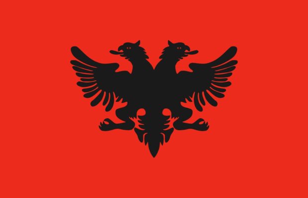 The double headed eagle symbol representing Albania on a vivid red background