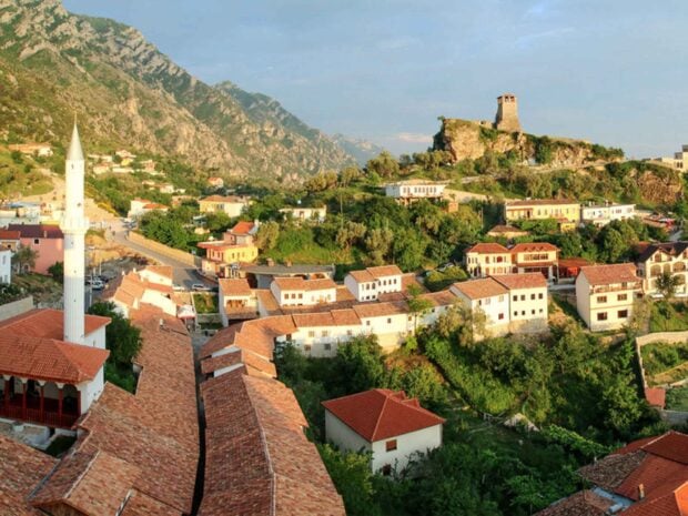 A scenic village in Albania surrounded by mountains and green landscapes