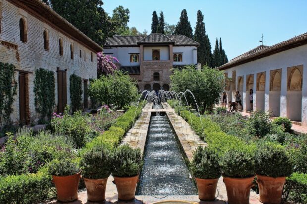 Historic Alhambra garden with fountains and lush greenery in a beautiful courtyard