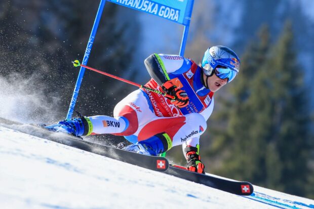 Alpine skiing athlete racing down the slope during a competition in high speed