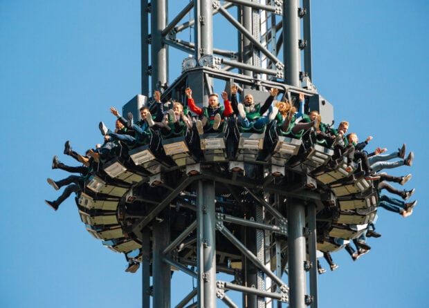 People enjoying a thrilling drop tower ride at an amusement park