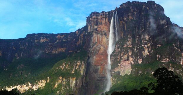 Angel Falls waterfall cascading down the rocky cliff surrounded by greenery