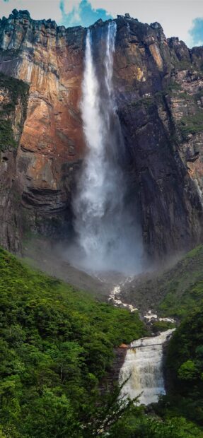 Angel Falls cascading down the cliff surrounded by lush green forest in Angel Falls