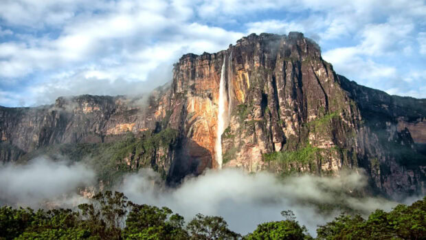 Angel Falls is a stunning natural landmark with rocky cliffs and lush greenery