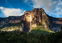 Angel Falls is a stunning natural waterfall surrounded by lush green forest and mountains