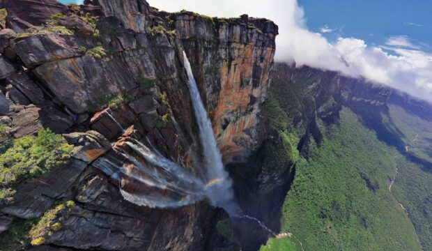 Angel Falls is a stunning natural waterfall surrounded by lush greenery and rock formations