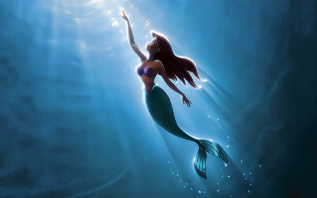Ariel The Little Mermaid swimming upwards with light beams underwater reaching towards the surface