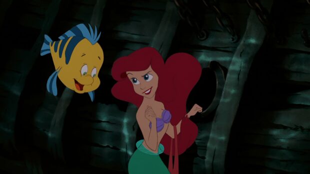 Ariel the little mermaid with her friend fish inside a sunken ship