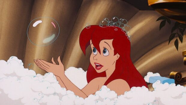 Ariel The Little Mermaid enjoying bubbles while sitting in a bath filled with foam