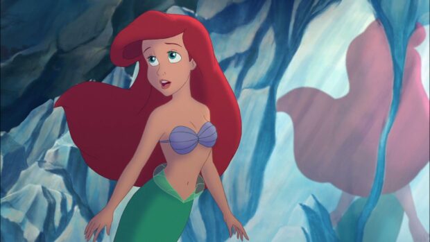 Ariel from The Little Mermaid cartoon character with red hair and green tail in a cave setting