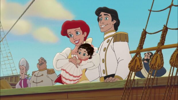 Ariel and her family smiling on a ship deck with Ariel holding a baby girl