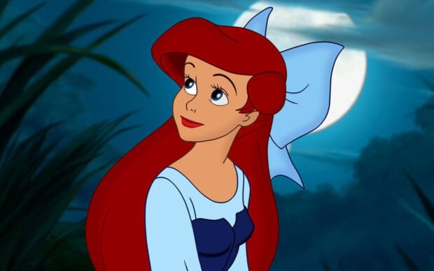 Ariel The Little Mermaid character looking up with a blue bow in her hair