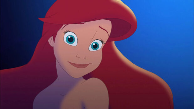 Ariel The Little Mermaid character with red hair and blue eyes underwater