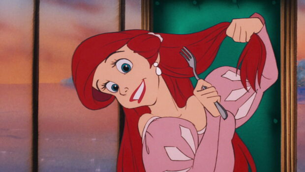 Ariel The Little Mermaid brushing her hair with a fork in a pink dress