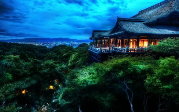 Traditional Asian temple surrounded by lush green trees at dusk in Asia