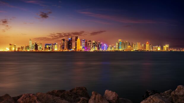 Stunning cityscape of Asia skyline with vibrant lights and calm water at sunset