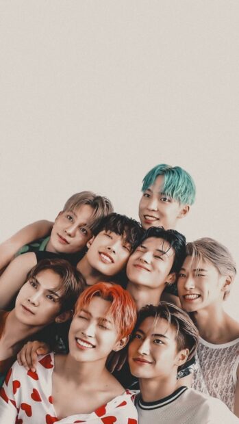 Ateez group smiling together in a close pose with vibrant hair colors