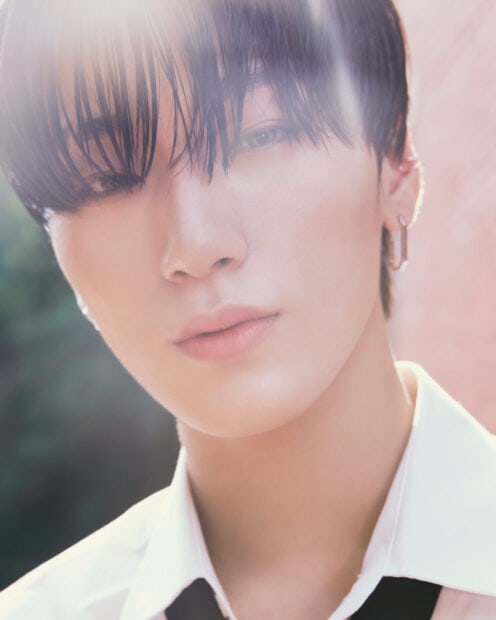 Close up portrait of Ateez member with wet hair and earring