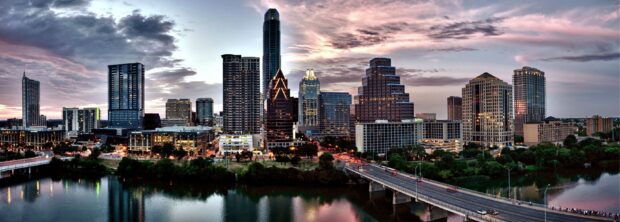 Austin skyline with river reflections under a cloudy evening sky