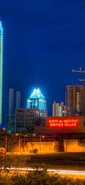 The city of Austin skyline featuring power plant and illuminated buildings at night