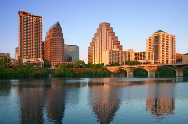 The Austin skyline with distinctive buildings and riverside reflections at sunset