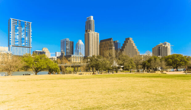 The Austin cityscape featuring high rise buildings and green park in bright daylight