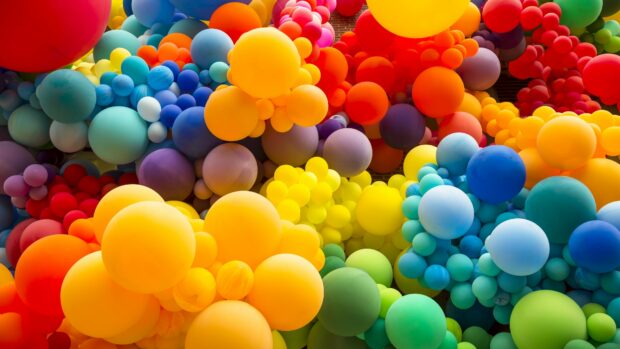 A vibrant cluster of colorful balloons filling the entire frame in a decorative arrangement