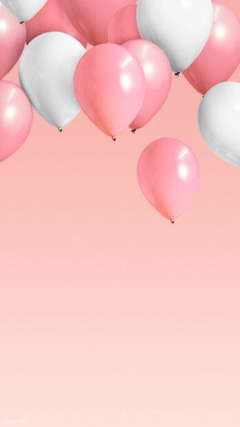 Pink and white balloons floating against a soft pink sky with balloons