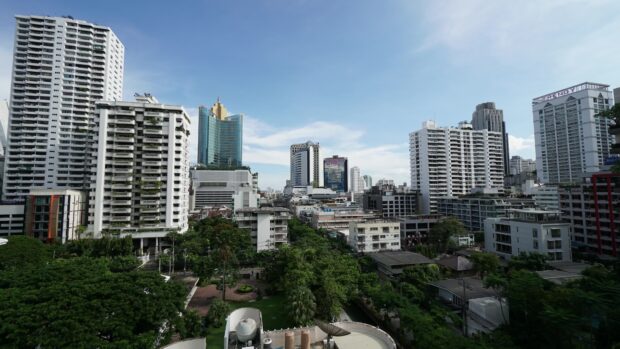 A clear view of Bangkok skyline featuring modern buildings and lush greenery in the cityscape