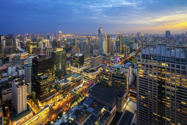 Stunning Bangkok cityscape at dusk featuring modern skyscrapers and vibrant street lights