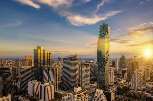 Modern cityscape with Bangkok skyline during golden hour featuring iconic skyscrapers and clear sky