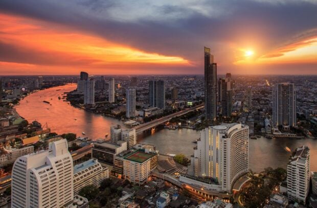 A breathtaking view of Bangkok skyline at sunset showing city buildings and river in high definition quality